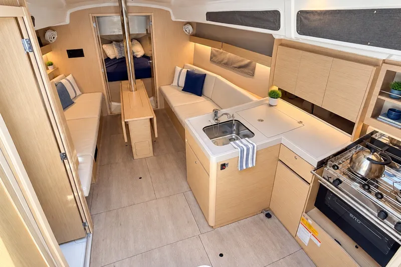 Slide: The Image of 2024 Beneteau Oceanis 34.1 yacht interior with modern kitchen and cozy seating area. - 3