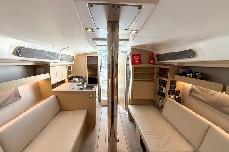 Slide: The Image of Interior of 2024 Beneteau Oceanis 34.1 yacht, featuring modern seating and kitchen area. - 26