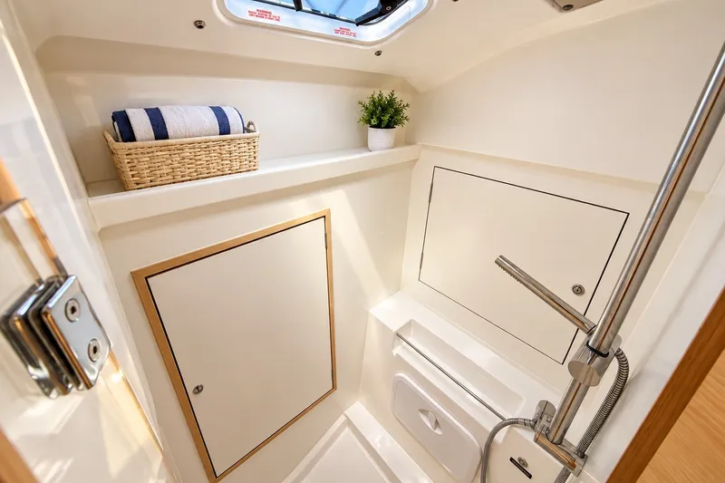 Slide: The Image of 2024 Beneteau Oceanis 34.1 yacht bathroom with modern shower and storage. - 11