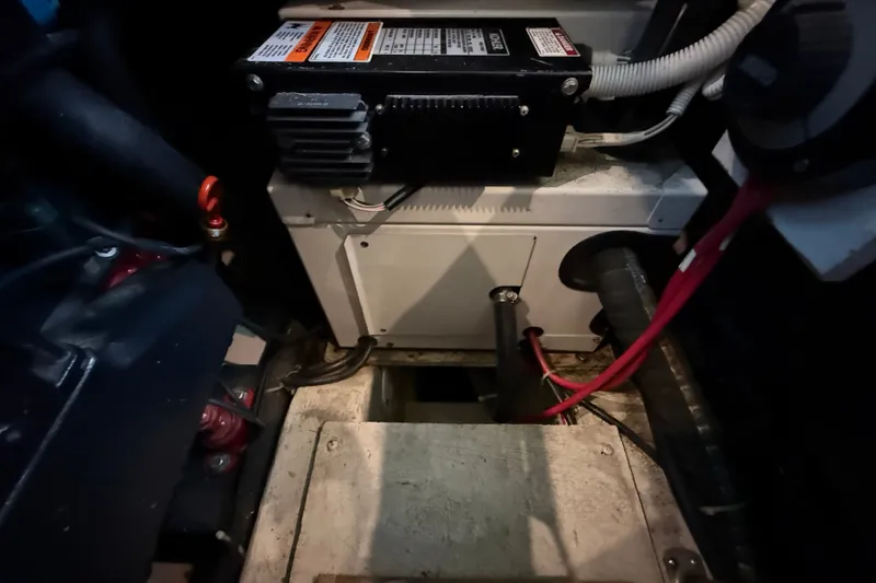 Slide: The Image of Engine compartment of a 2002 Carver 404 Cockpit Motor Yacht, showing electrical components and wiring. - 70