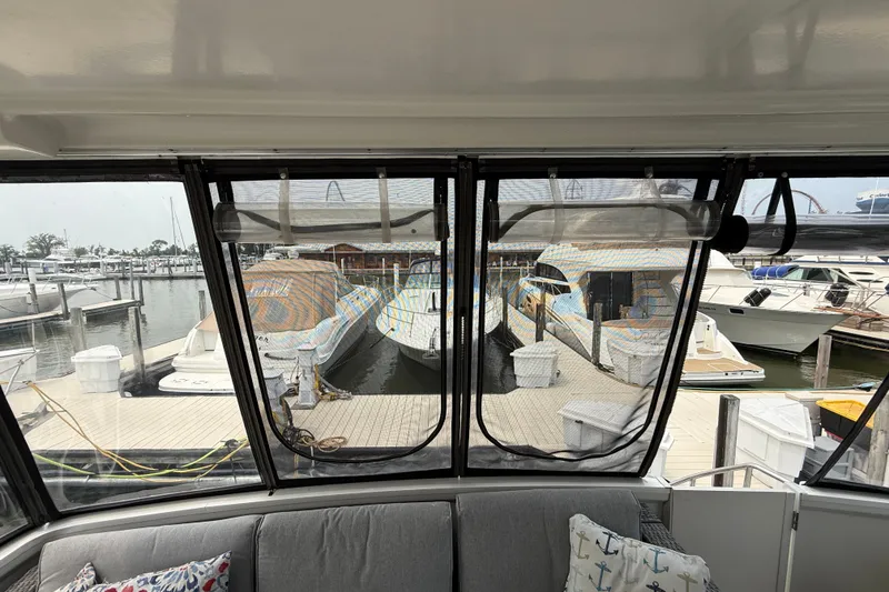 Slide: The Image of View from 2002 Carver 404 Cockpit Motor Yacht, overlooking marina with docked boats. - 13