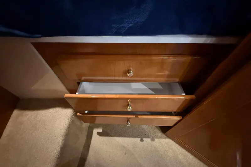 Slide: The Image of Wooden drawers in a 2002 Carver 404 Cockpit Motor Yacht interior. - 56