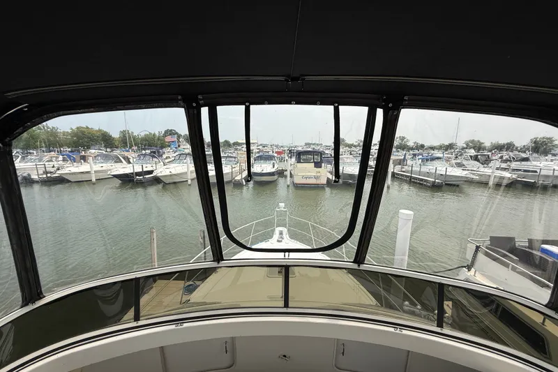 Slide: The Image of View from 2002 Carver 404 Cockpit Motor Yacht overlooking marina with multiple boats docked. - 32