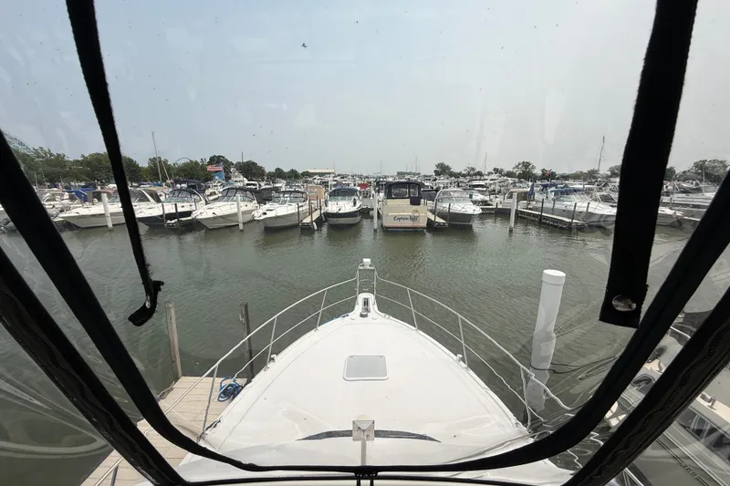 Slide: The Image of View from 2002 Carver 404 Cockpit Motor Yacht docked at a marina with boats. - 33