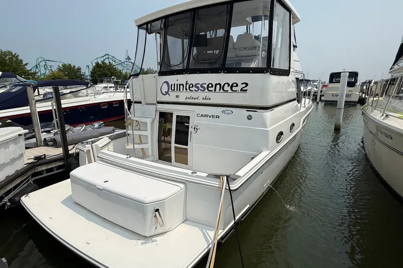 Slide: The Image of 2002 Carver 404 Cockpit Motor Yacht docked, featuring spacious deck and enclosed cockpit. - 3