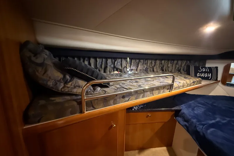 Slide: The Image of Cozy cabin interior of 2002 Carver 404 Cockpit Motor Yacht with cushioned bed and "Sail Away" pillow. - 55