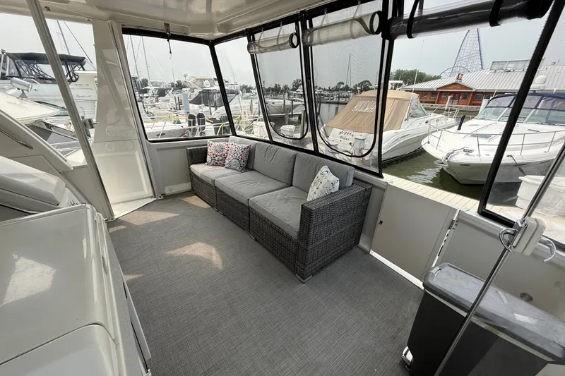 Slide: The Image of Spacious cockpit of 2002 Carver 404 Motor Yacht with comfortable seating and marina view. - 9