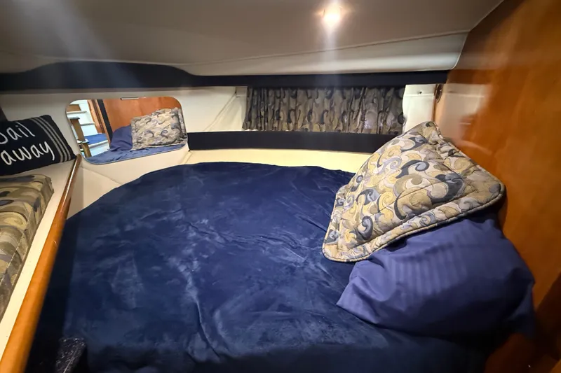 Slide: The Image of Cozy cabin interior of 2002 Carver 404 Cockpit Motor Yacht with plush bedding. - 54