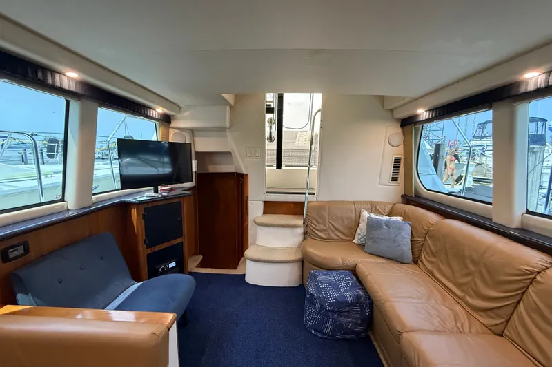 Slide: The Image of Luxurious interior of 2002 Carver 404 Cockpit Motor Yacht with leather seating and TV. - 57