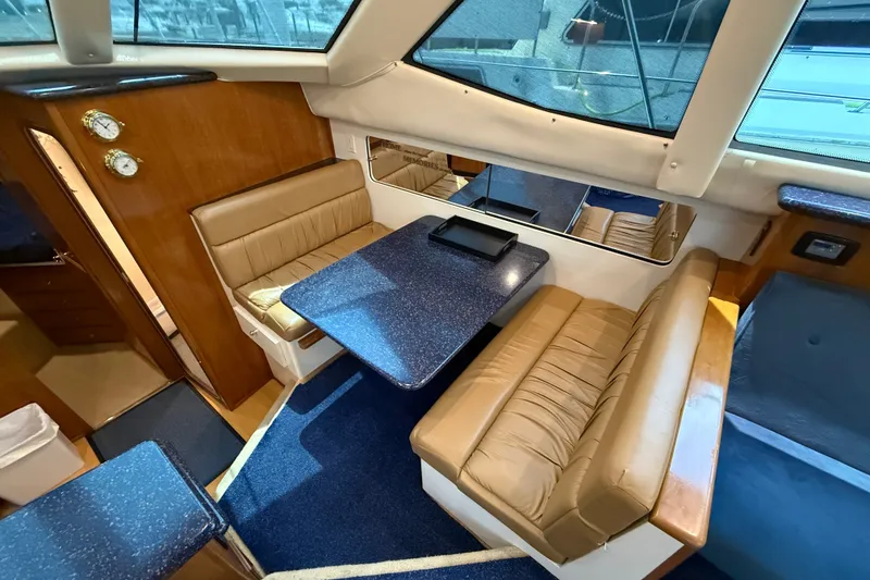 Slide: The Image of Interior of 2002 Carver 404 Cockpit Motor Yacht with cozy seating and dining area. - 39