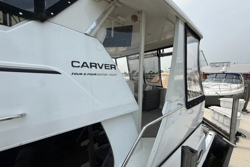 Slide: The Image of 2002 Carver 404 Cockpit Motor Yacht docked at marina, side view. - 6