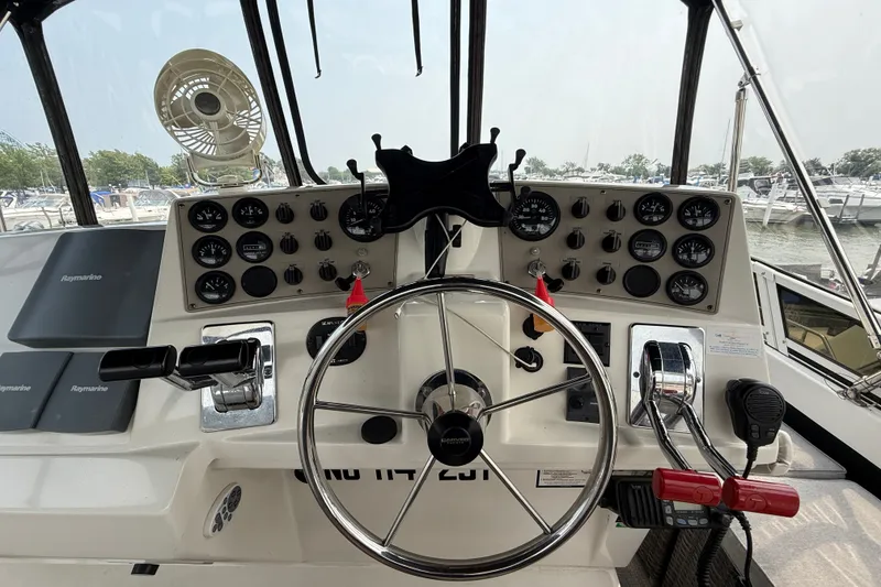 Slide: The Image of Cockpit of 2002 Carver 404 Cockpit Motor Yacht with steering wheel and control panel. - 24
