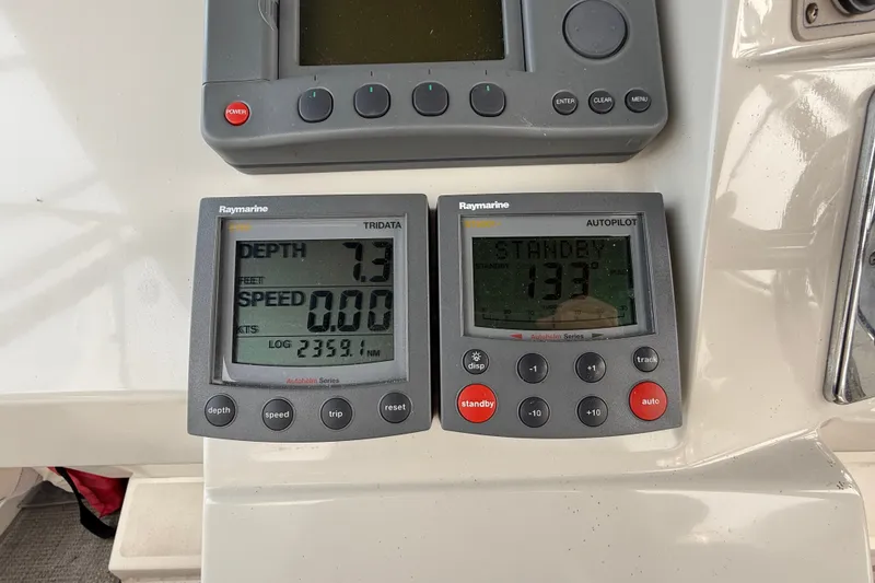 Slide: The Image of Raymarine navigation instruments on 2002 Carver 404 Cockpit Motor Yacht dashboard. - 28