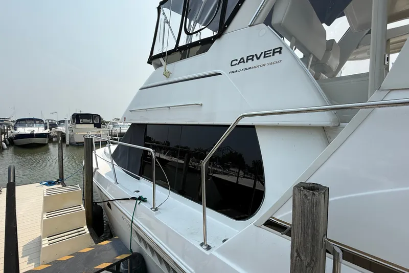 Slide: The Image of 2002 Carver 404 Cockpit Motor Yacht docked at marina, side view. - 5