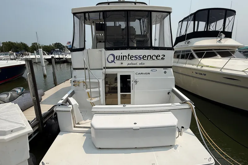 Slide: The Image of 2002 Carver 404 Cockpit Motor Yacht docked at marina, rear view. - 4