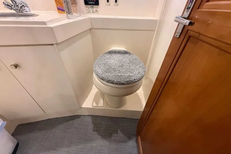 Slide: The Image of Bathroom interior of 2002 Carver 404 Cockpit Motor Yacht with toilet and sink. - 52