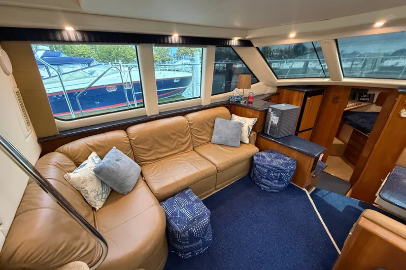 Slide: The Image of Luxurious interior of 2002 Carver 404 Cockpit Motor Yacht with leather seating and nautical decor. - 35