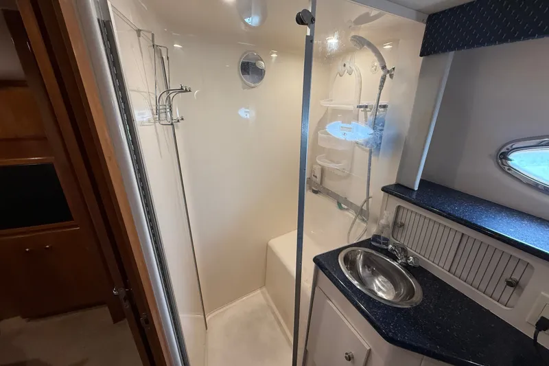 Slide: The Image of Luxurious bathroom in 2002 Carver 404 Cockpit Motor Yacht with shower and sink. - 64