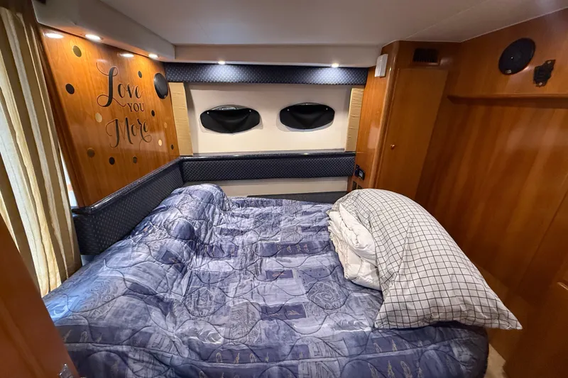 Slide: The Image of Cozy bedroom in 2002 Carver 404 Cockpit Motor Yacht with decorative wall and bedding. - 60