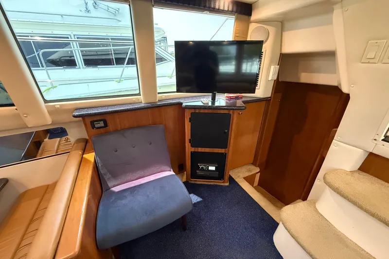 Slide: The Image of Interior of 2002 Carver 404 Cockpit Motor Yacht with seating, TV, and stairs. - 37