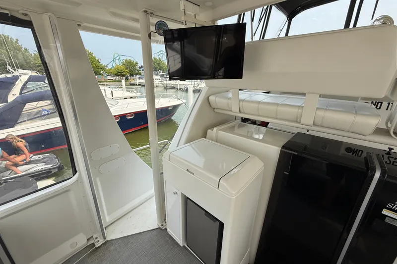 Slide: The Image of Interior of 2002 Carver 404 Cockpit Motor Yacht with seating and appliances. - 14