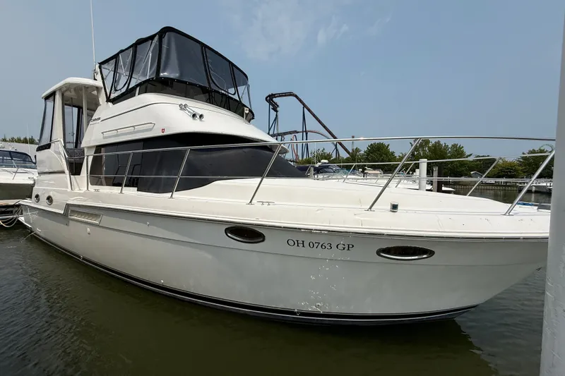 Slide: The Image of 2002 Carver 404 Cockpit Motor Yacht docked in marina, side view. - 2