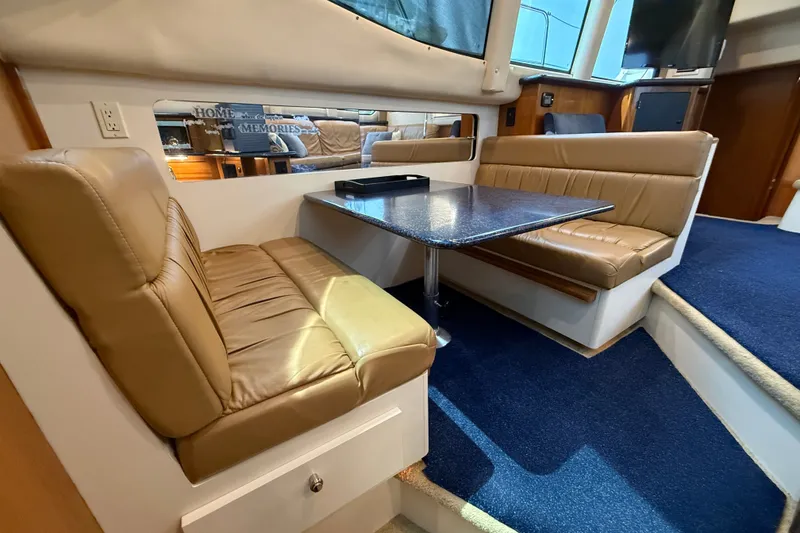 Slide: The Image of Interior of 2002 Carver 404 Cockpit Motor Yacht with leather seating and dining table. - 41