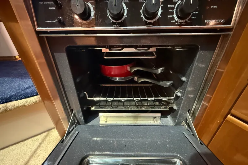Slide: The Image of Oven interior with red cookware on a yacht, Carver 404 Cockpit Motor Yacht, 2002. - 49