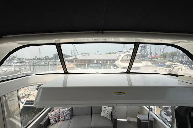 Slide: The Image of Interior view of 2002 Carver 404 Cockpit Motor Yacht with marina backdrop. - 23