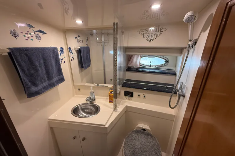 Slide: The Image of Bathroom interior of 2002 Carver 404 Cockpit Motor Yacht with sink, shower, and decor. - 50