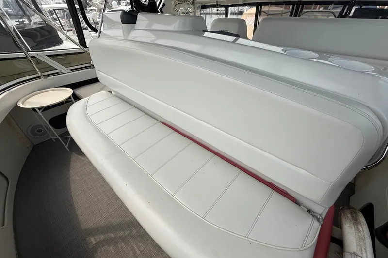 Slide: The Image of 2002 Carver 404 Cockpit Motor Yacht interior with white seating and small table. - 31