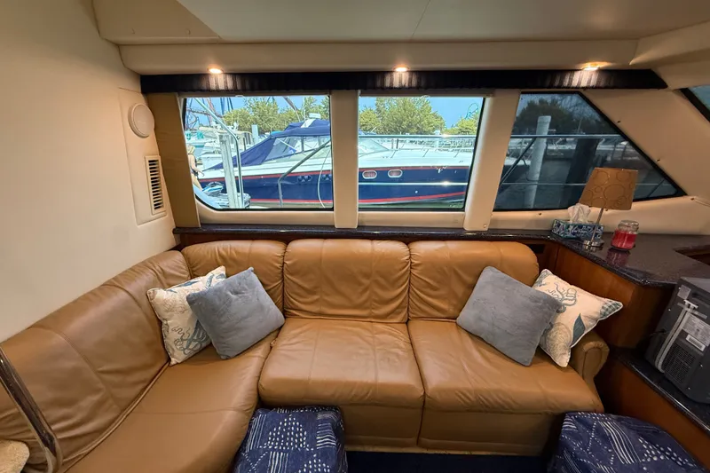 Slide: The Image of Interior of 2002 Carver 404 Cockpit Motor Yacht with leather seating and decorative pillows. - 38