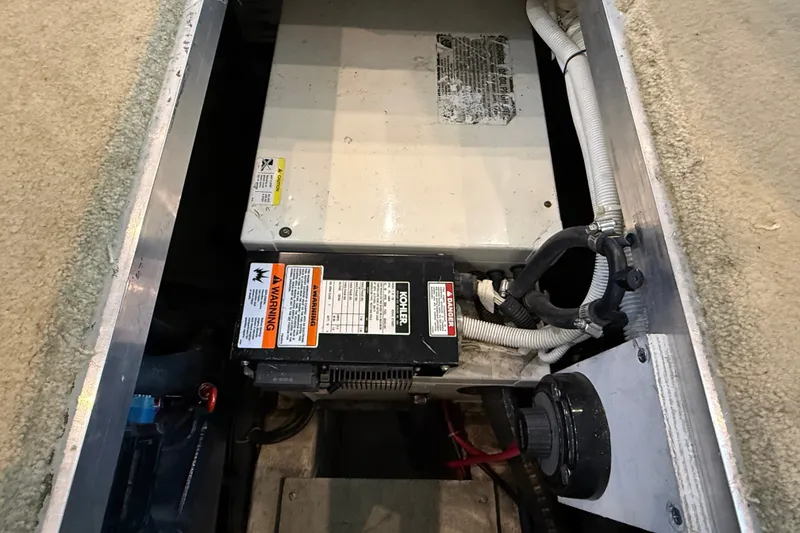 Slide: The Image of Engine compartment of 2002 Carver 404 Cockpit Motor Yacht, featuring Kohler generator. - 69