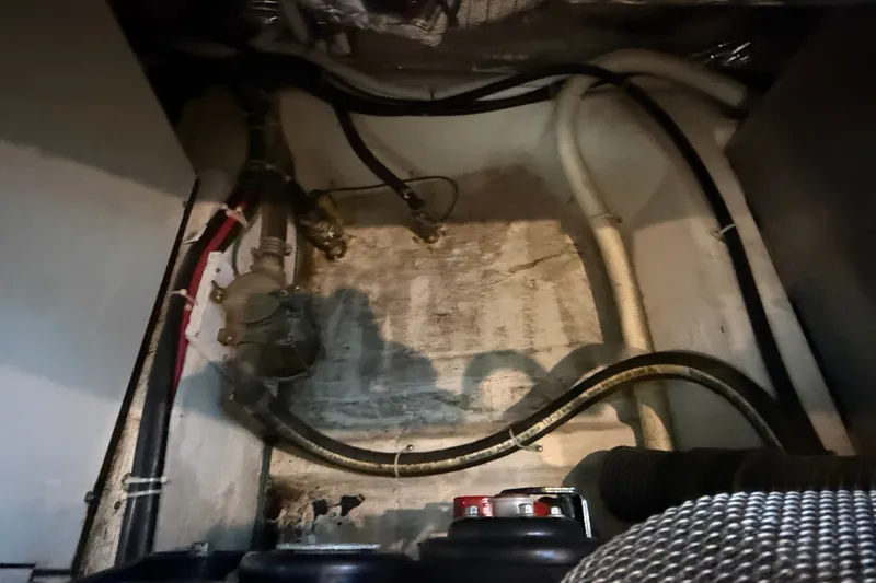 Slide: The Image of Engine compartment of a 2002 Carver 404 Cockpit Motor Yacht, showing hoses and wiring. - 73