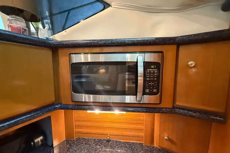 Slide: The Image of Microwave in 2002 Carver 404 Cockpit Motor Yacht kitchen with wooden cabinetry. - 45