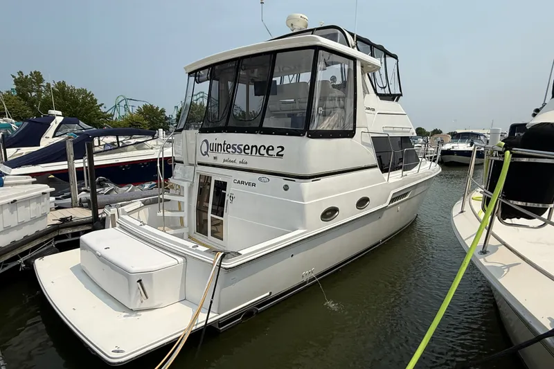 The Image of 2002 Carver 404 Cockpit Motor Yacht docked in marina, rear view. - 0
