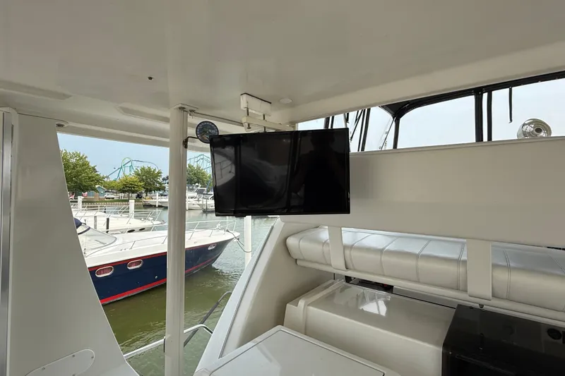 Slide: The Image of Interior of 2002 Carver 404 Cockpit Motor Yacht with mounted TV and marina view. - 15