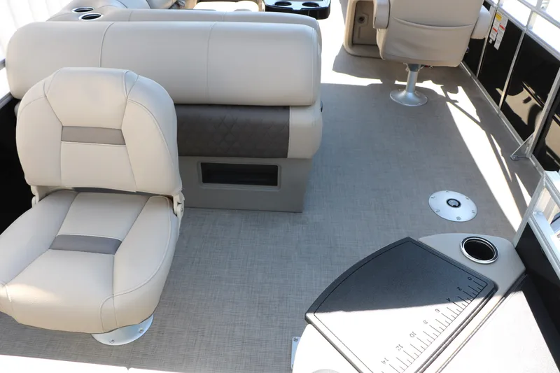 Slide: The Image of 2025 Sun Tracker SportFish 20 DLX interior with beige seating and fishing station. - 17