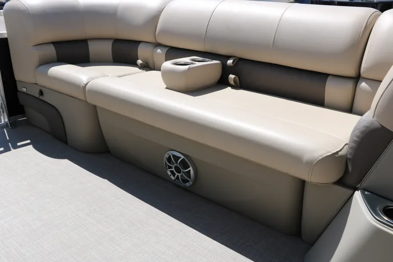 Slide: The Image of 2025 Sun Tracker SportFish 20 DLX boat interior with beige seating and cup holders. - 27