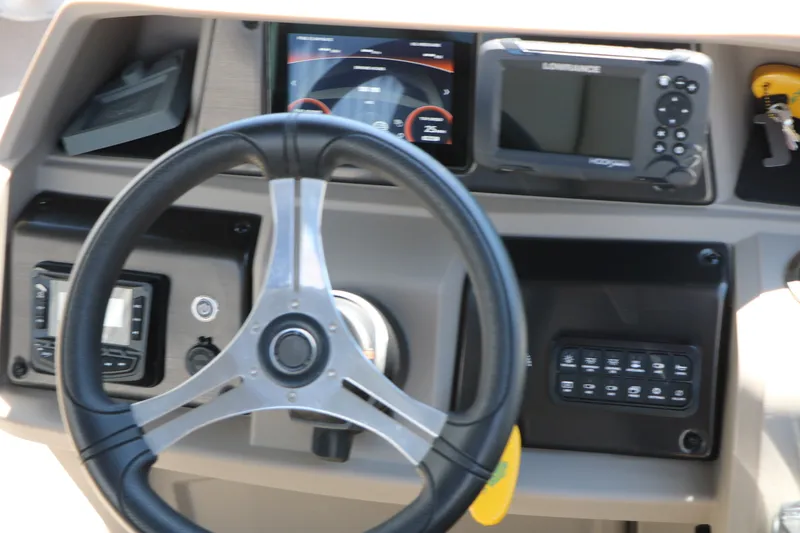 Slide: The Image of Steering console of 2025 Sun Tracker SportFish 20 DLX with navigation equipment. - 32