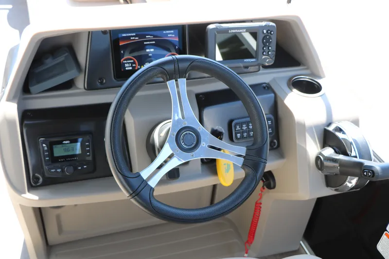 Slide: The Image of Steering console of 2025 Sun Tracker SportFish 20 DLX with modern controls and displays. - 23