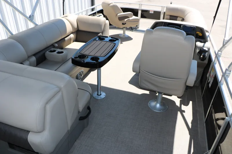 Slide: The Image of 2025 Sun Tracker SportFish 20 DLX pontoon boat interior with beige seating and table. - 18