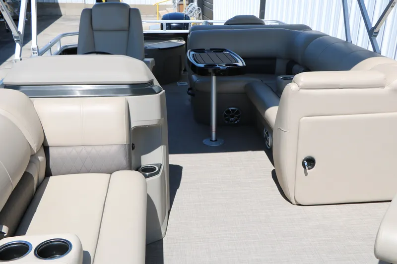 Slide: The Image of 2025 Sun Tracker SportFish 20 DLX pontoon boat interior with beige seating and table. - 15