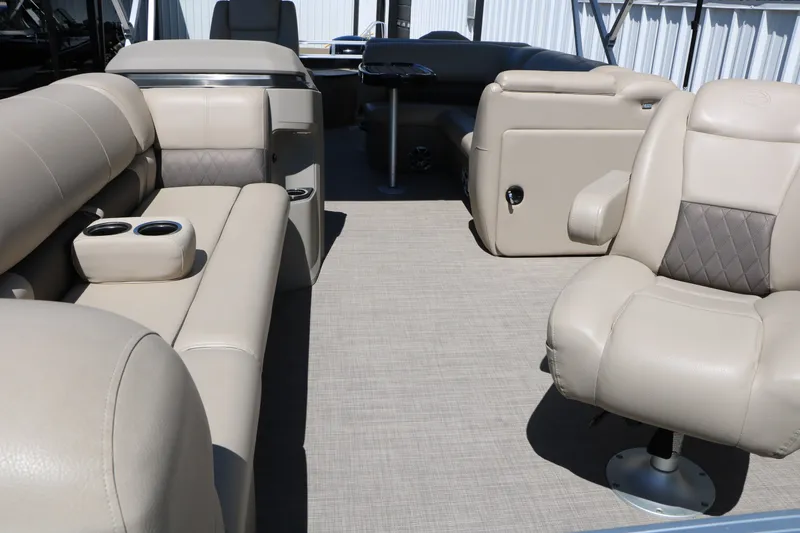 Slide: The Image of 2025 Sun Tracker SportFish 20 DLX interior with beige seating and cup holders. - 14