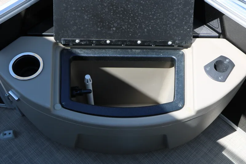 Slide: The Image of 2025 Sun Tracker SportFish 20 DLX boat storage compartment with cup holder and open lid. - 37