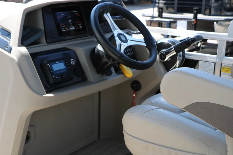 Slide: The Image of 2025 Sun Tracker SportFish 20 DLX boat dashboard with steering wheel and controls. - 39