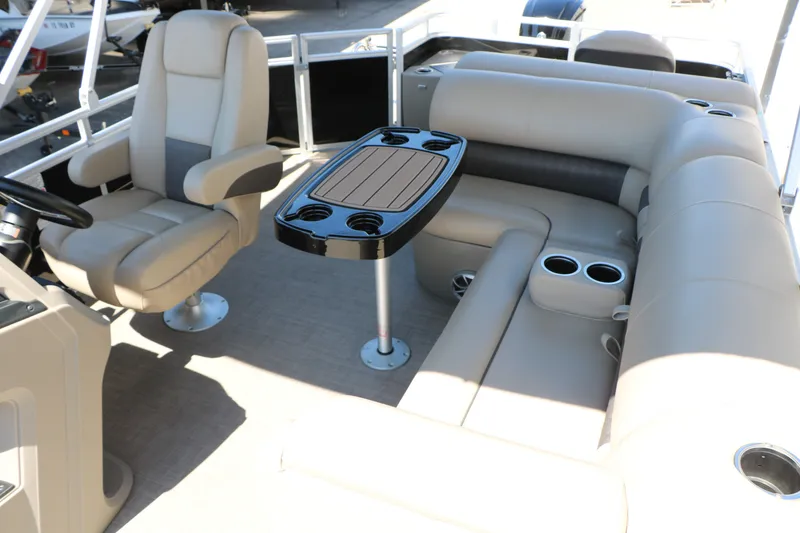Slide: The Image of 2025 Sun Tracker SportFish 20 DLX interior with beige seating and a central table. - 30