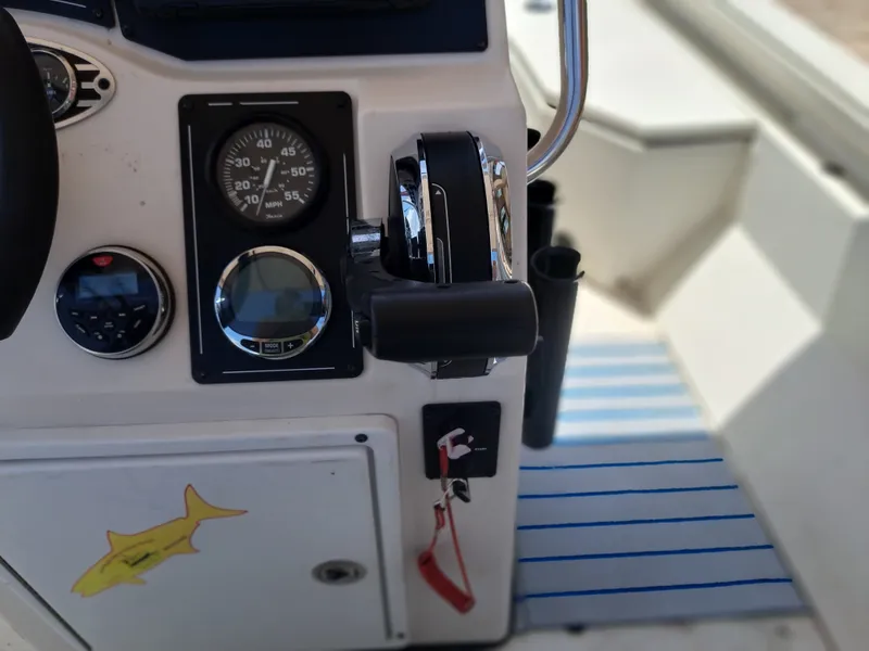 Slide: The Image of The image shows the cockpit of a 2022 Ranger RB190 boat with controls and instruments. - 25