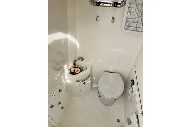 Slide: The Image of Interior of 2008 Edgewater 318CC boat bathroom with toilet and sink. - 10