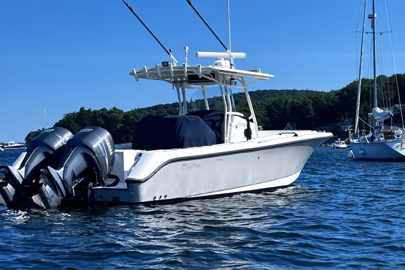 Slide: The Image of 2008 Edgewater 318CC boat with twin Yamaha engines on a sunny day. - 20